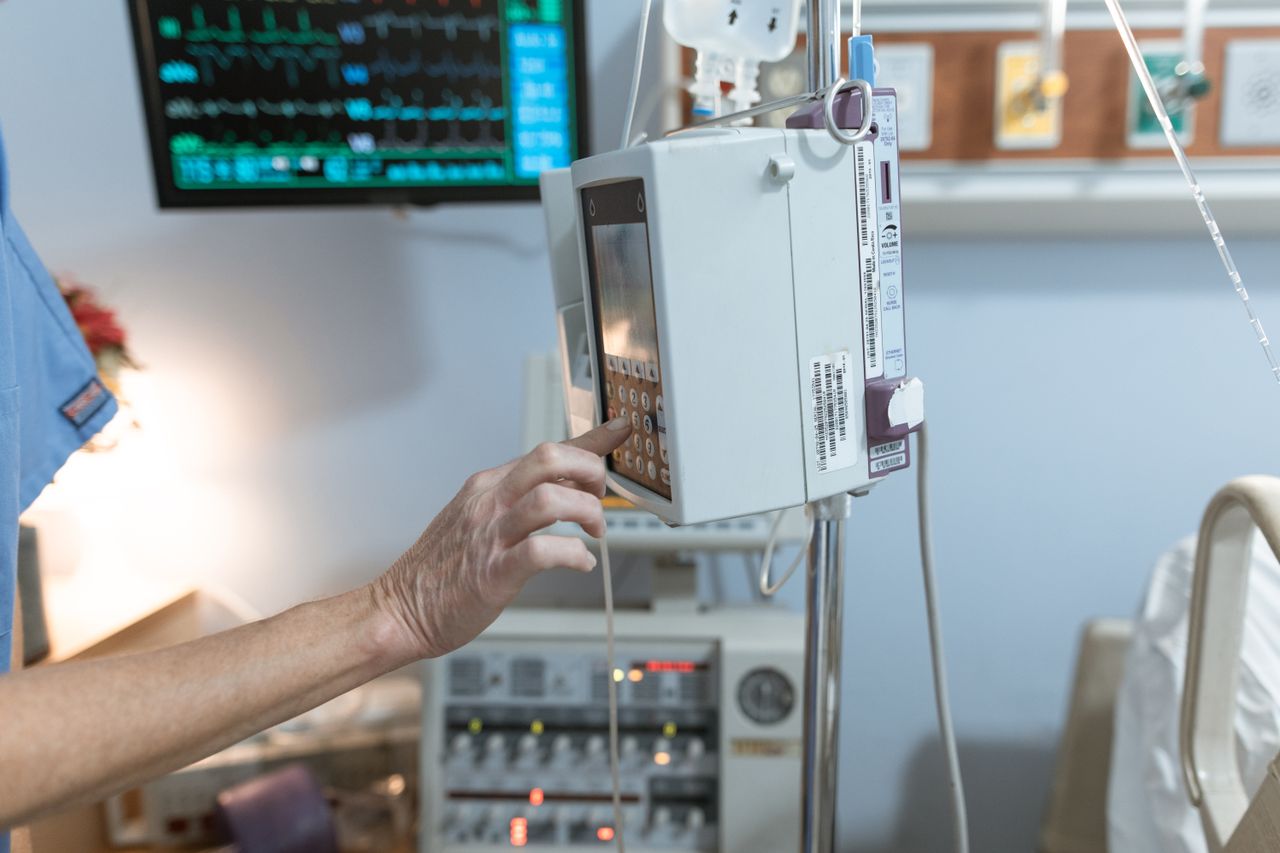 Home A healthcare worker operates a modern infusion pump in a hospital setting, ensuring precise medication delivery.