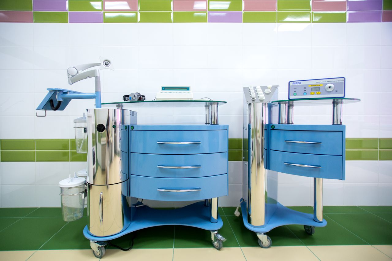 Services Two modern dental equipment carts in a sterile clinic environment, emphasizing hygiene.